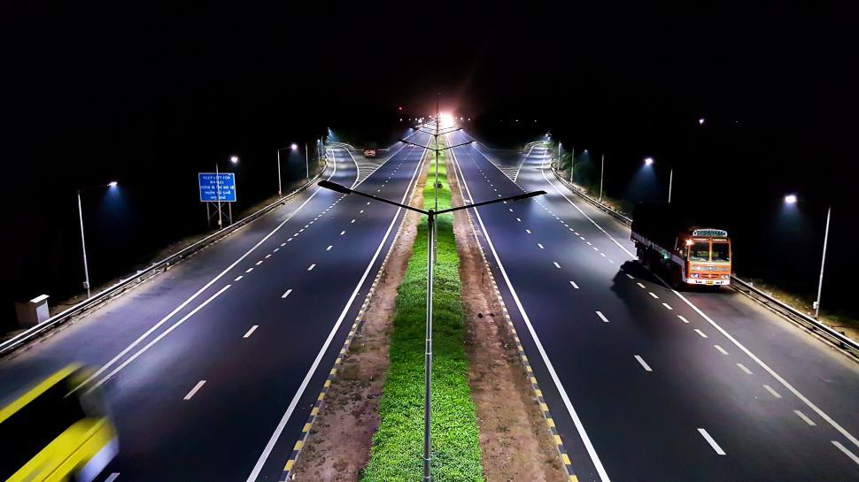 Free Image of A Car Speeding Down a Highway at Night 