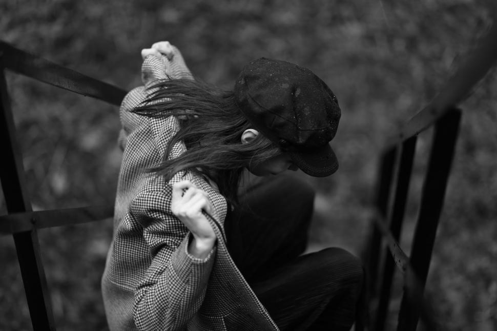 Free Image of Person Sitting on Chair With Hat On 
