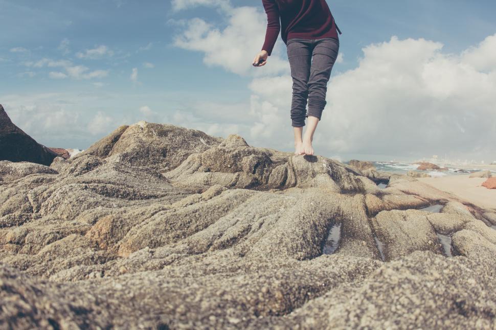 Free Image of Man Walking Along Sandy Beach by Ocean 