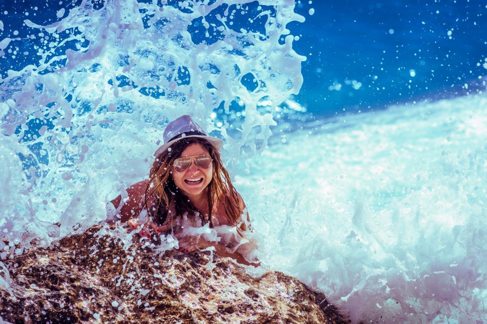 Free Image of Woman Laying on Surfboard in Ocean 