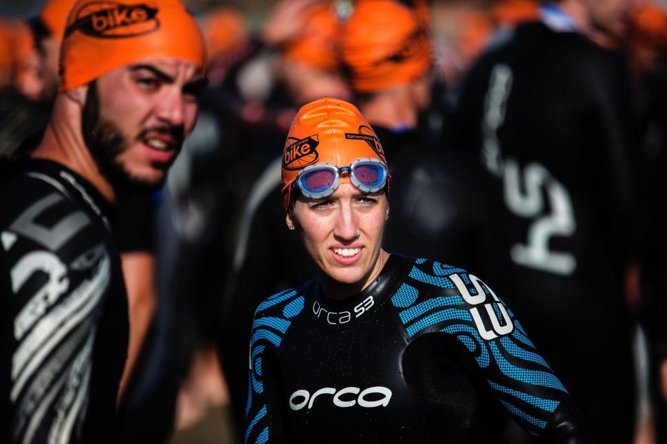 Free Image of Group of Bicyclists Wearing Orange Hats and Goggles 