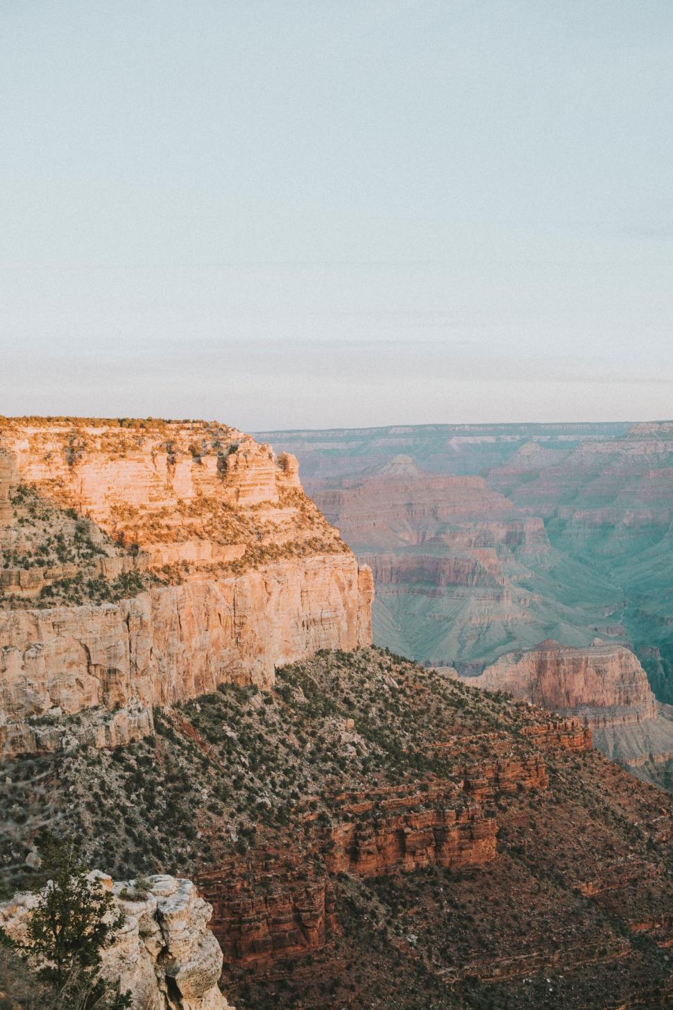 Free Image of Man Standing on Cliff Next to River 