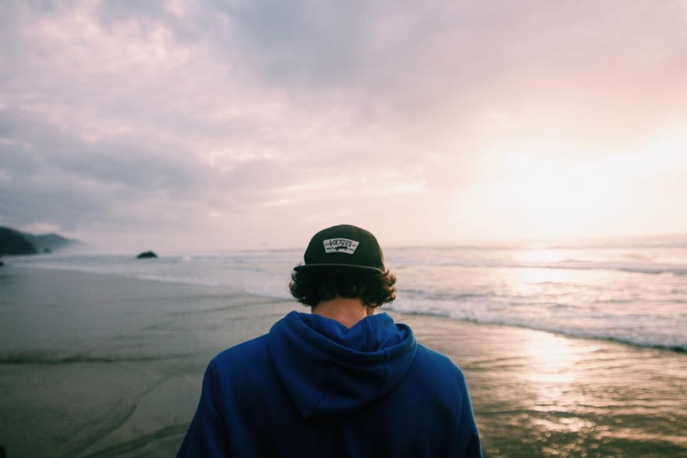 Free Image of Person Standing on Beach Near Ocean 
