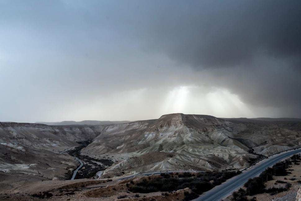 Free Image of Road Cutting Through Desert Under Cloudy Sky 