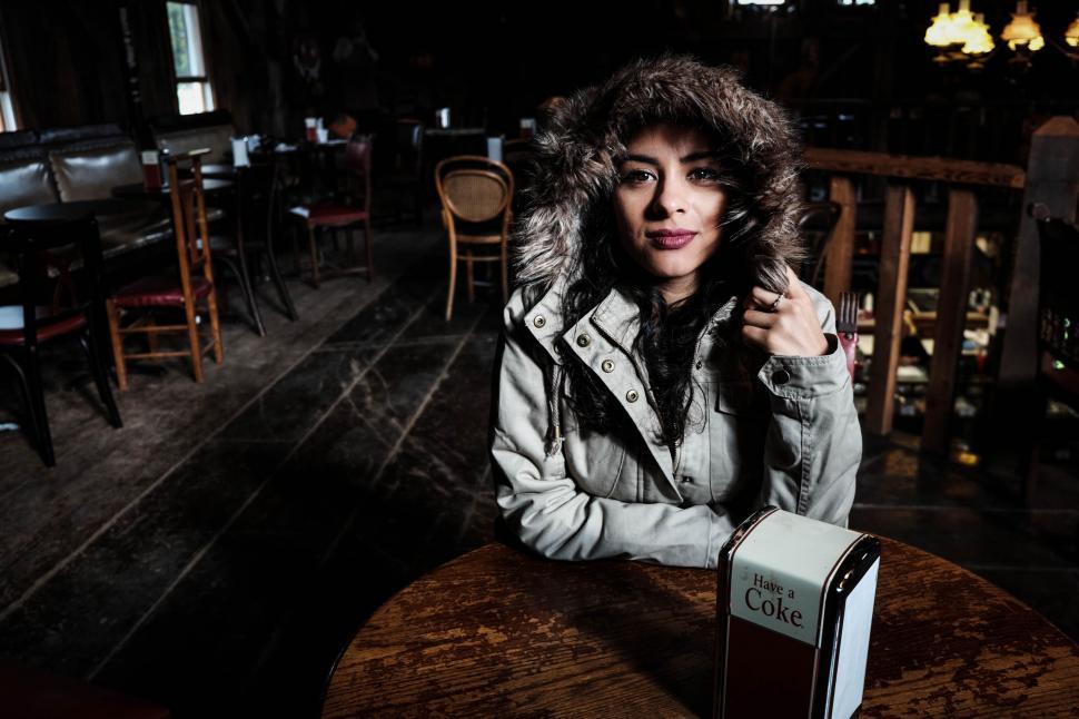 Free Image of Woman Sitting at a Table in a Restaurant 