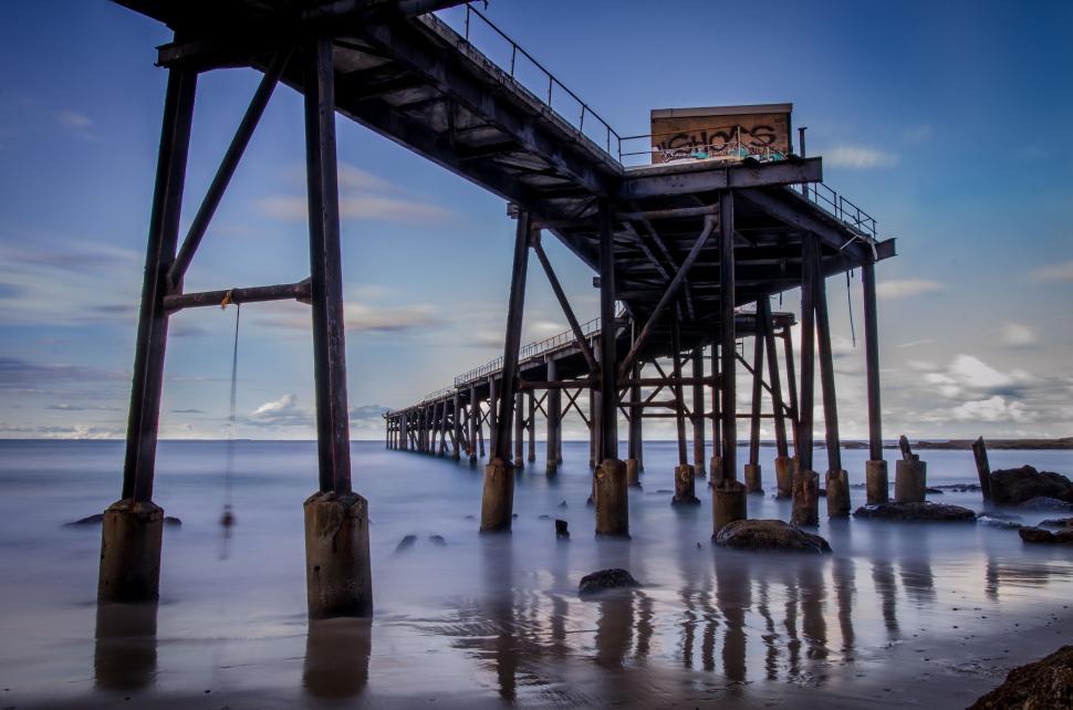 Free Image of Signboard Atop a Long Pier 