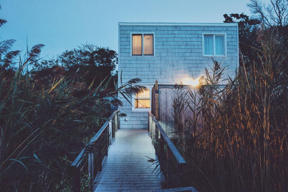 Free Image of House Illuminated on Wooden Walkway at Night 
