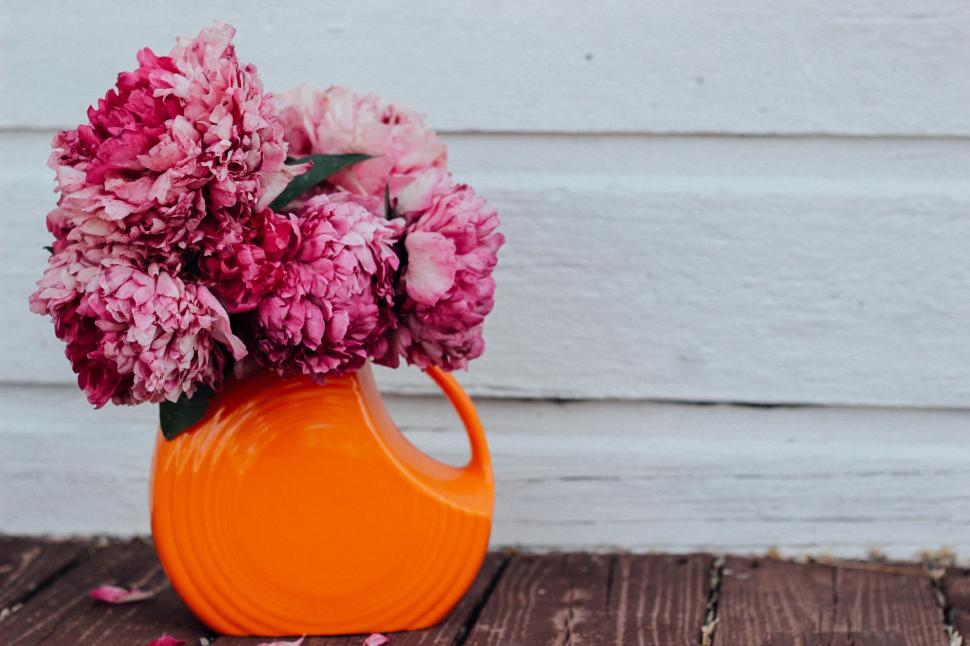 Free Image of Vase Filled With Pink Flowers on Wooden Table 