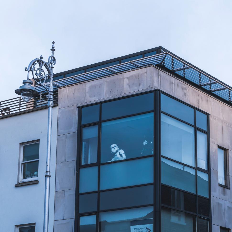 Free Image of Person Looking Out of Window in Tall Building 
