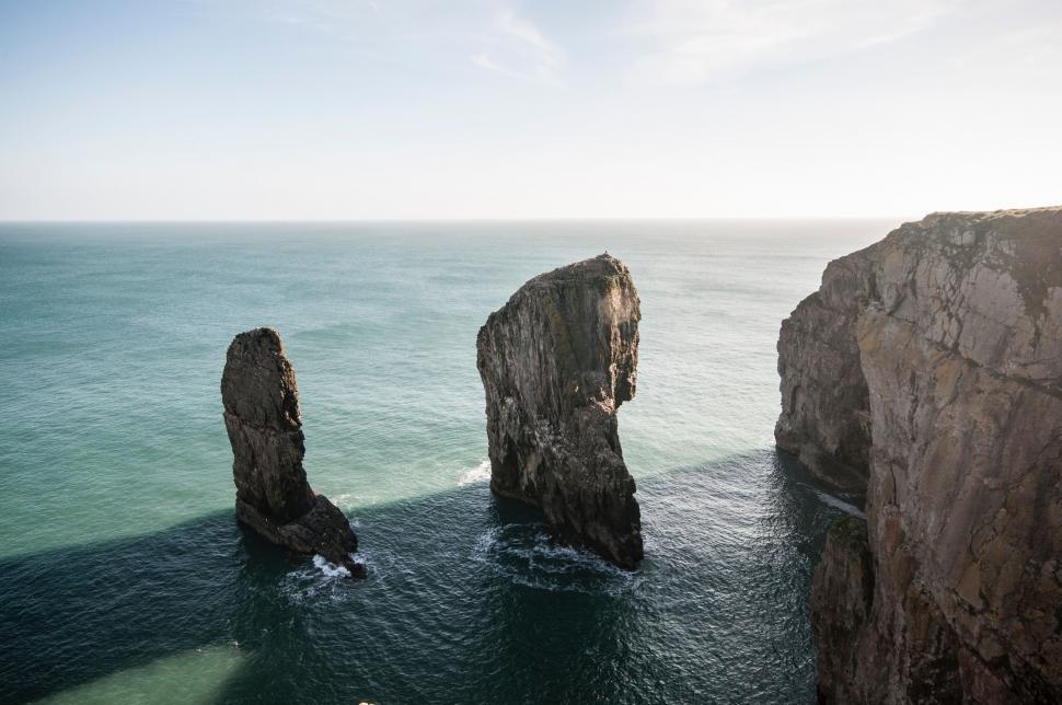 Free Image of Two Large Rocks Protruding From Ocean 