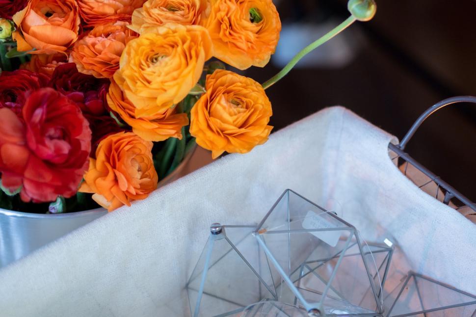 Free Image of Vase Filled With Orange and Red Flowers 