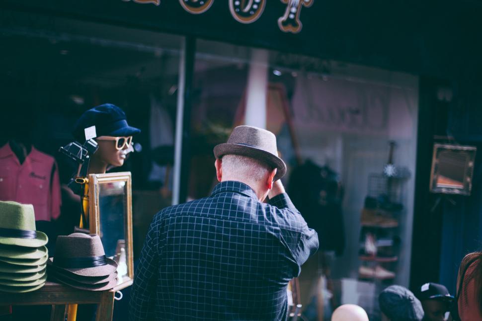 Free Image of Man Talking on Cell Phone Outside Store 