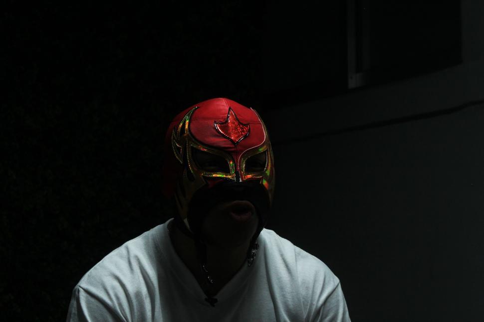 Free Image of Man Wearing Red Helmet in the Dark 