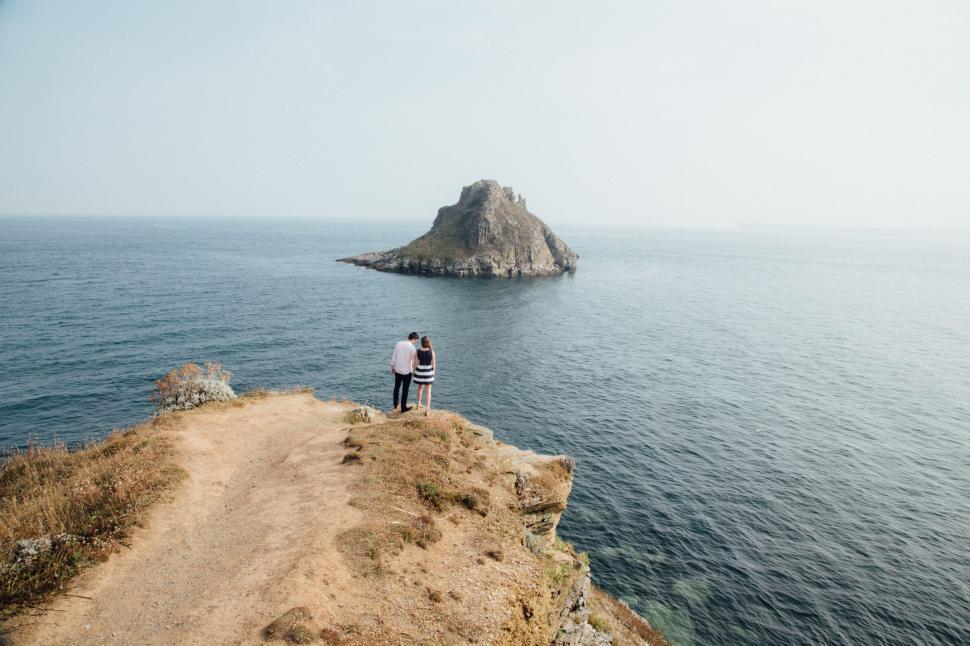 Free Image of Man Standing on Cliff Overlooking Ocean 