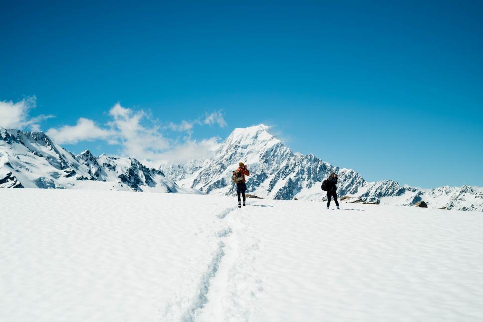 Free Image of Couple Walking Across Snow Covered Field 