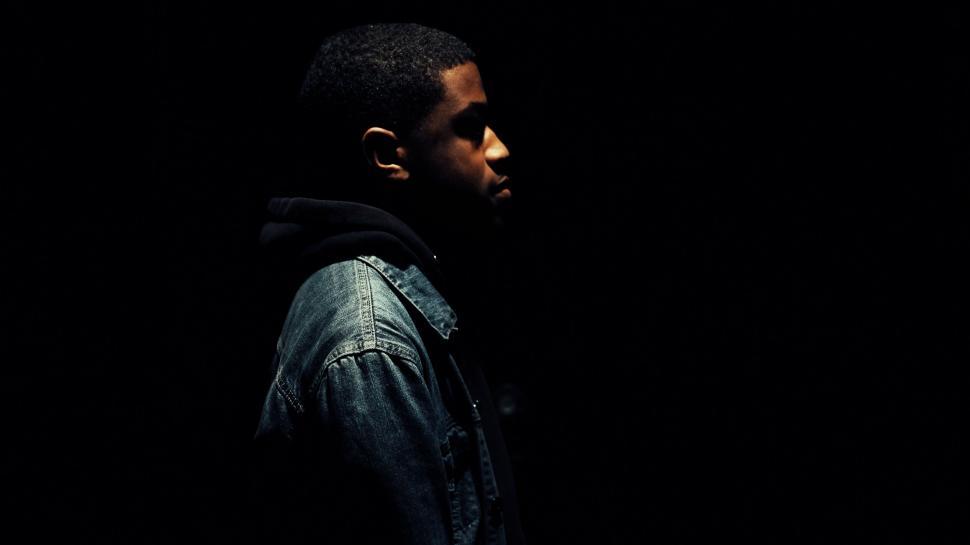 Free Image of Man Standing in Dark Wearing Denim Jacket 