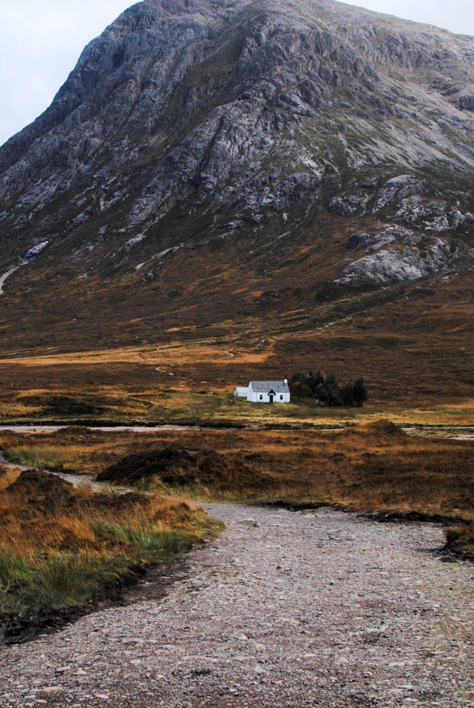 Free Image of House in a Field With Mountain Background 