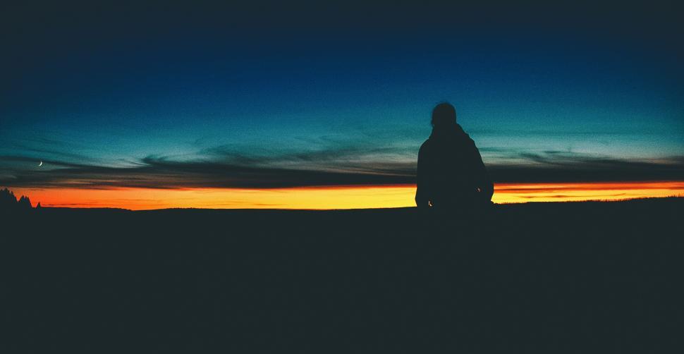 Free Image of Person Standing in Field at Sunset 