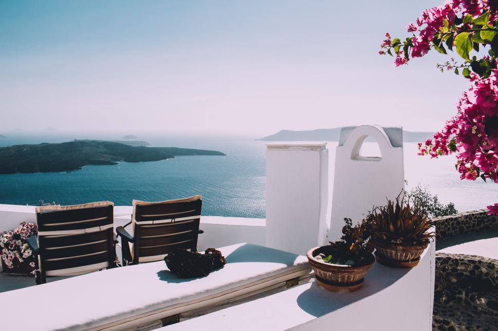 Free Image of Chairs on Top of White Building 