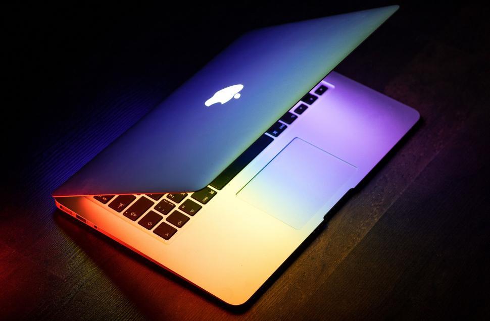 Free Image of Apple Laptop Computer on Wooden Table 