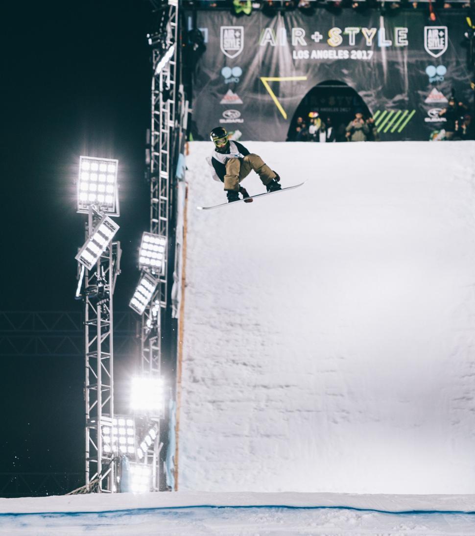 Free Image of Man Snowboarding Down Snowy Slope 