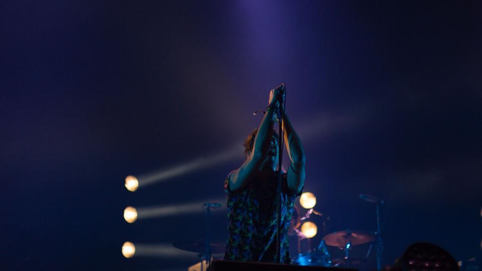 Free Image of Person Speaking on Stage With Microphone 