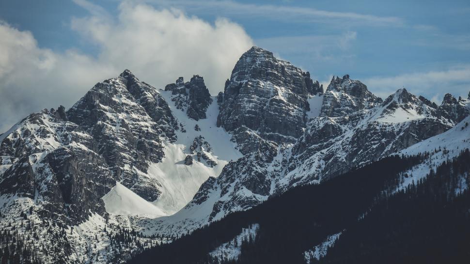 Free Image of Snow-Covered Mountain Range Under Blue Sky 
