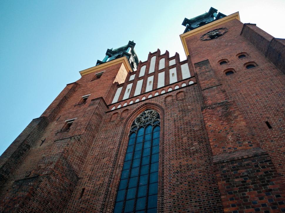 Free Image of Tall Brick Building With Clock on Side 