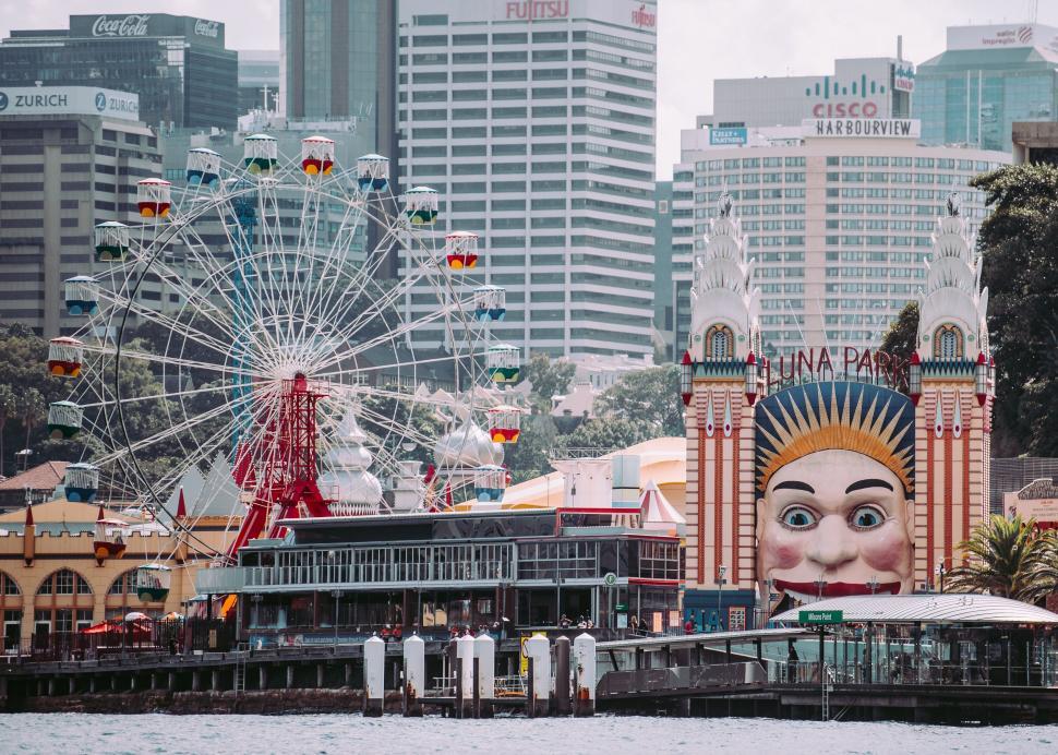 Free Image of Large Statue of Person on Pier in Front of City 