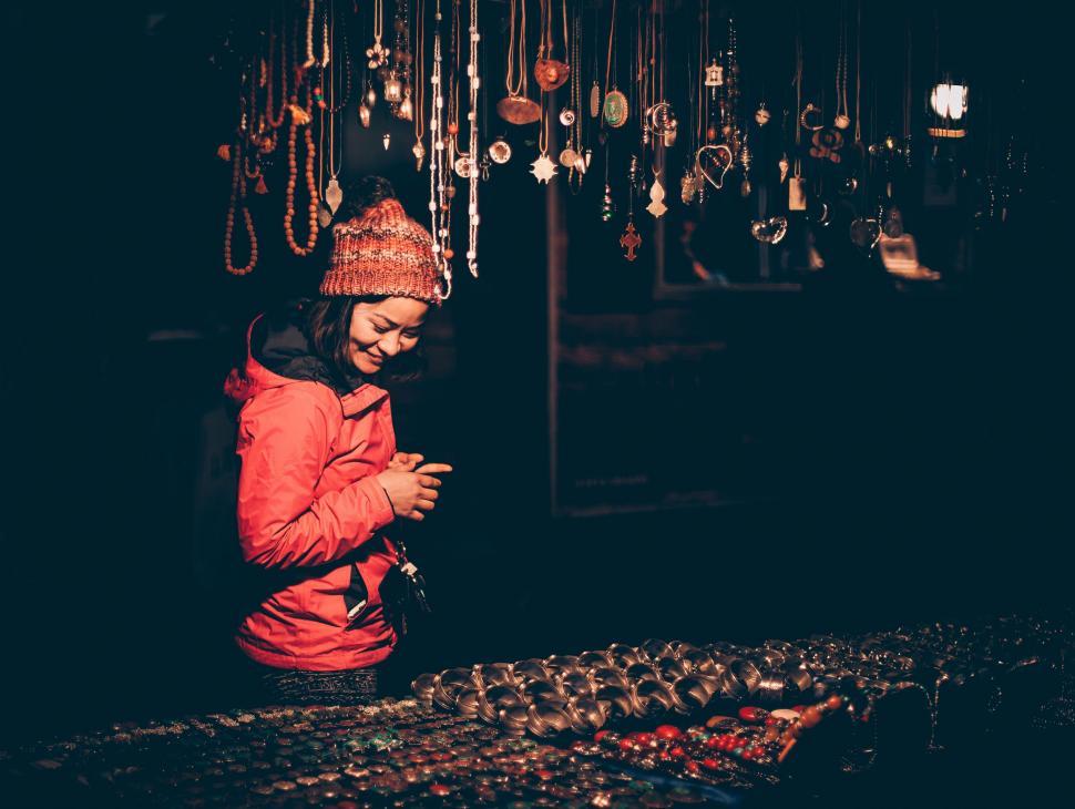 Free Image of Woman Standing in Front of Display of Jewelry 