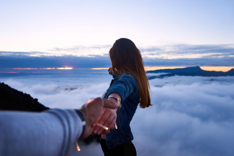 Free Image of Person Holding Another Above the Clouds 