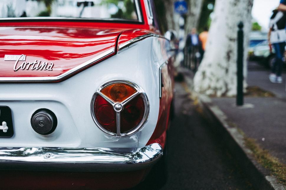 Free Image of Red and White Car Parked on Side of Road 