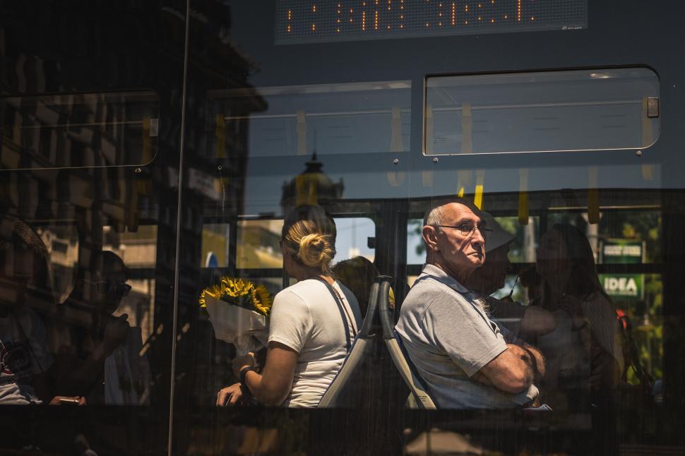 Free Image of Man and Woman Sitting on a Bus 