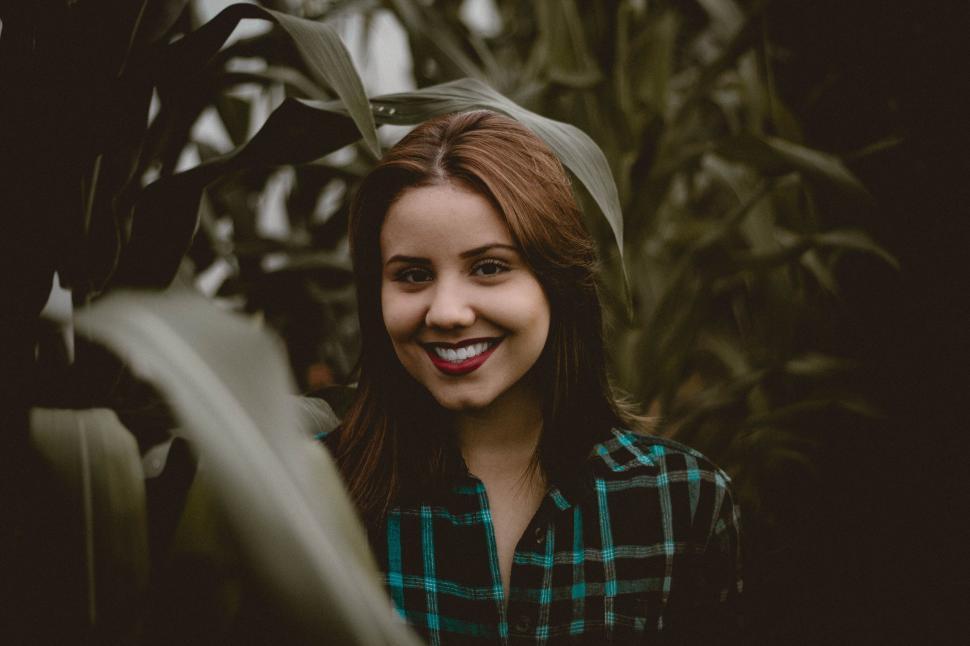 Free Image of Woman Standing in Front of Plants 