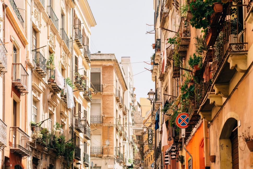 Free Image of Bustling Narrow City Street Amid Tall Buildings 