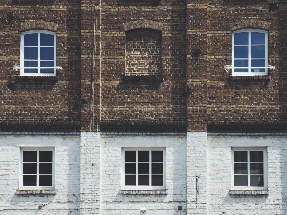 Free Image of Building With Three Windows and Clock 