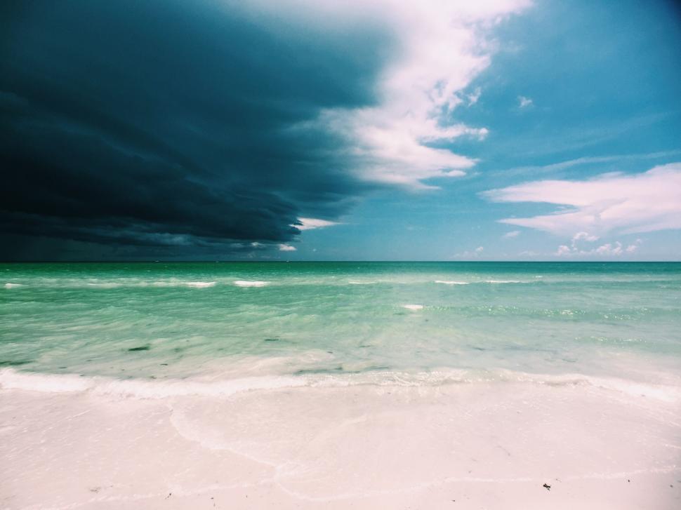 Free Image of A View of a Beach With the Ocean in the Background 