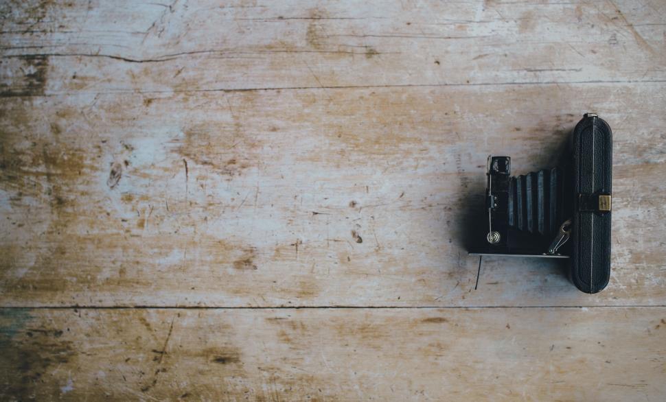 Free Image of Small Black Object on Wooden Surface 