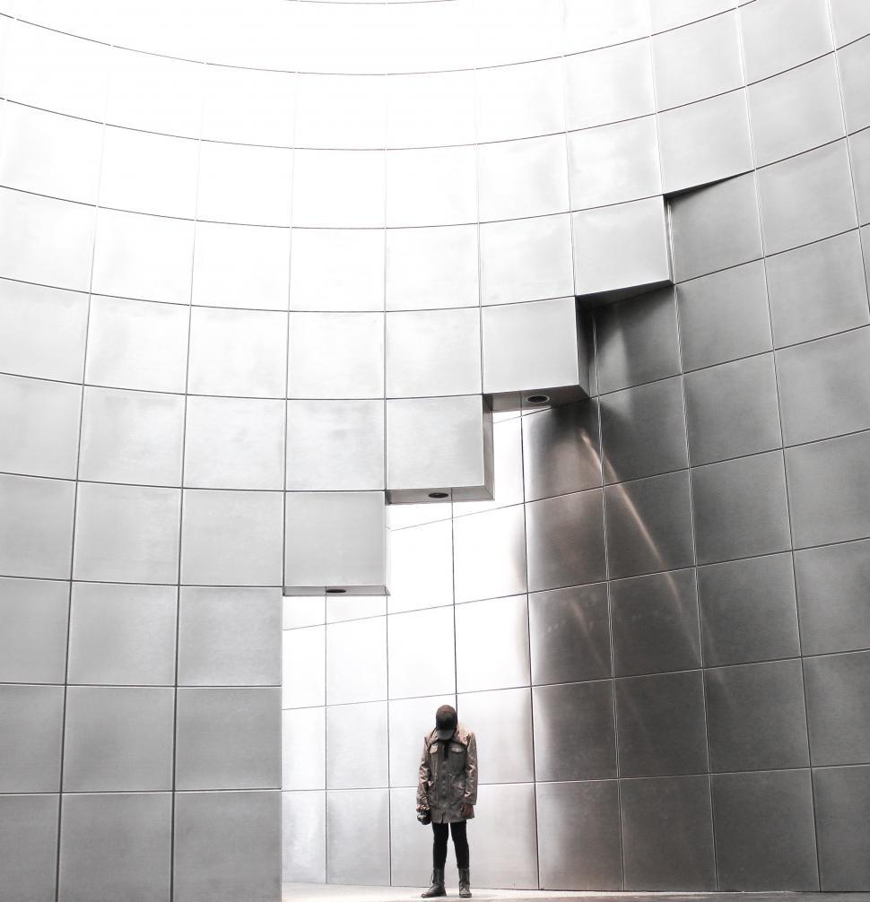 Free Image of Person Standing in Front of Large Building 