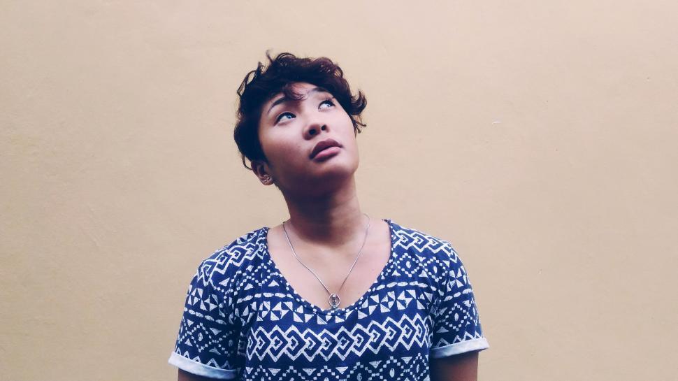 Free Image of Woman Looking Up in Surprise 