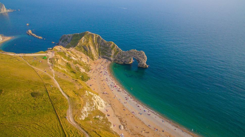 Free Image of Aerial View of a Beach With Rock Formation in Water 