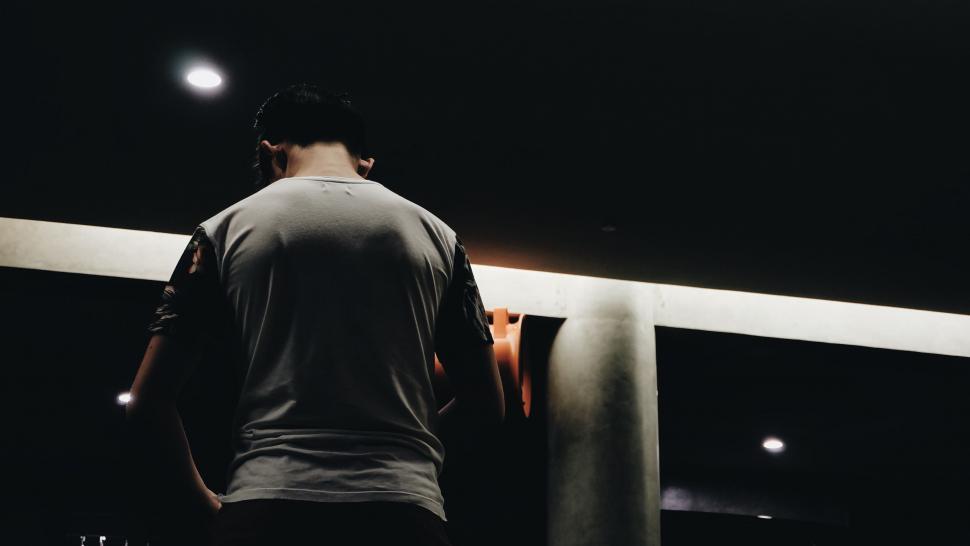 Free Image of Man Holding Skateboard in Front of Mirror 