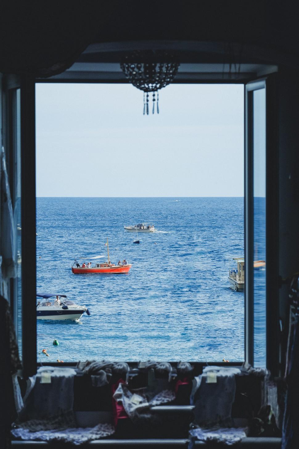 Free Image of Boat Sailing Past Window 