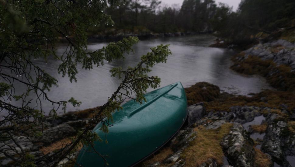 Free Image of Green Boat on Rocky Shore 
