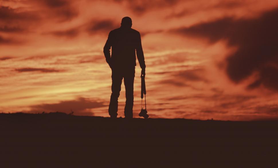 Free Image of Man Standing on Hill With Dog 
