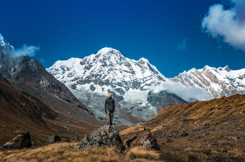 Free Image of Man Standing on Rock in Mountains 