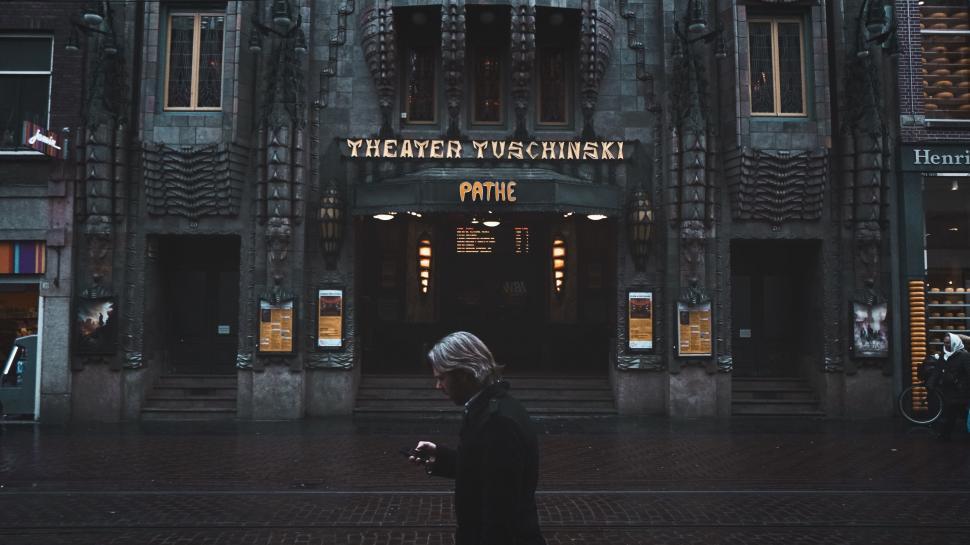 Free Image of Person Standing in Front of Tall Building 