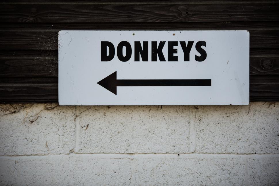 Free Image of White Sign With Black Arrow Pointing to the Right 