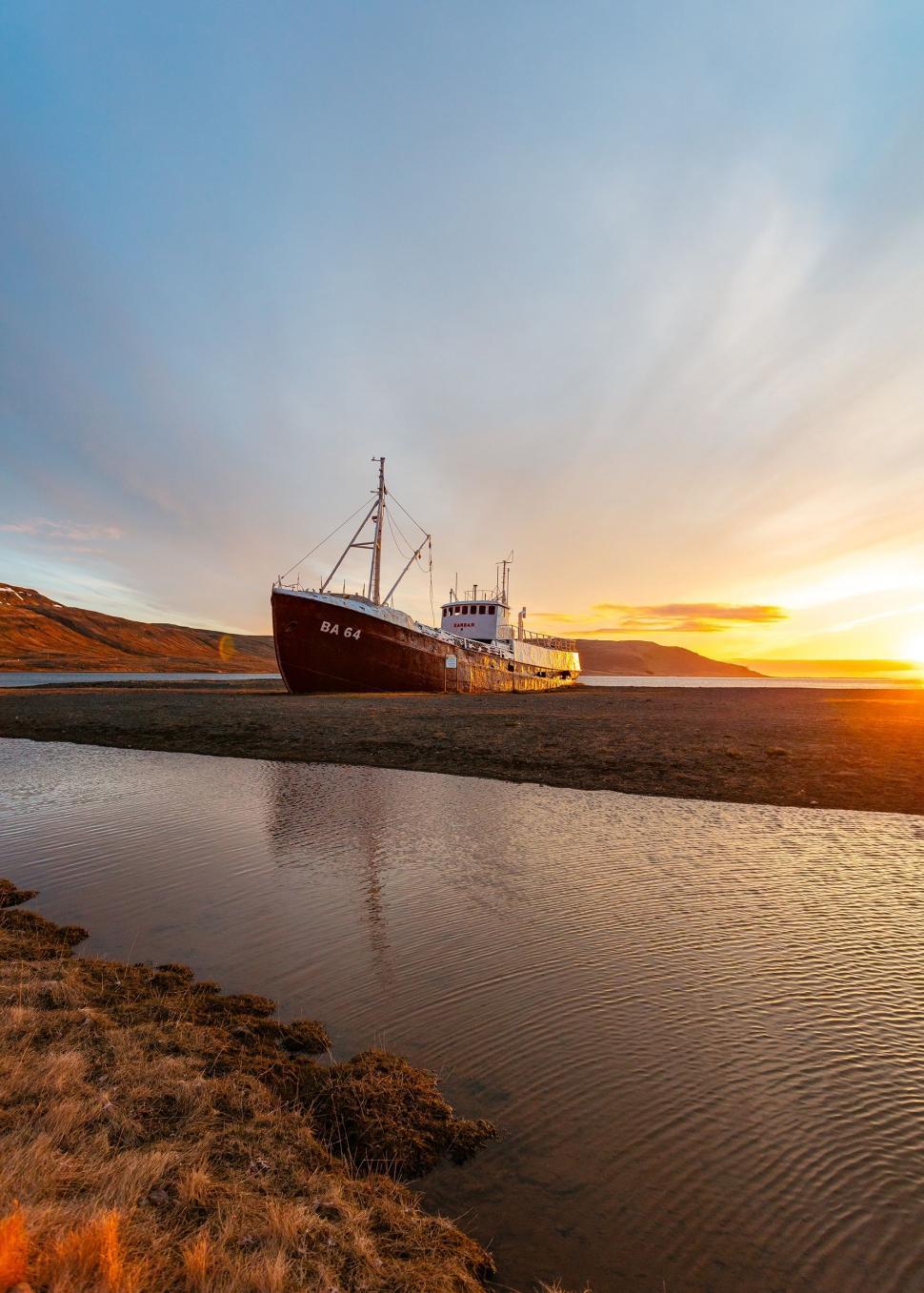 Free Image of Large Boat Floating on Body of Water 