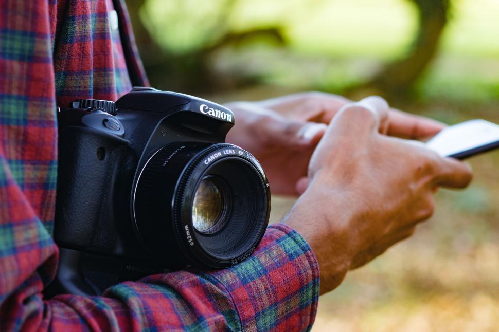 Free Image of Person Holding Camera and Cell Phone 